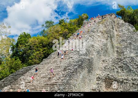 COBA, MEXICO - MARCH 1, 2016: Tourist climb the Pyramid Nohoch Mul at the ruins of the Mayan city Coba, Mexico Stock Photo