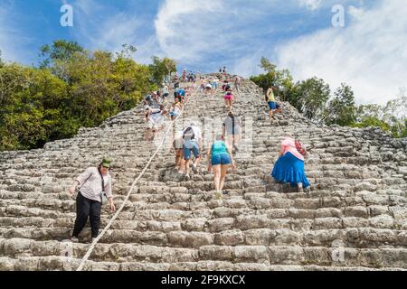 COBA, MEXICO - MARCH 1, 2016: Tourist climb the Pyramid Nohoch Mul at the ruins of the Mayan city Coba, Mexico Stock Photo