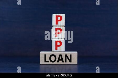 PPP, paycheck protection program loan symbol. Concept words PPP, paycheck protection program loan on wooden blocks on a beautiful grey background. Bus Stock Photo