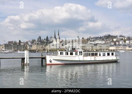 Cruise ship moored on pier in city harbor Lucerne. The vessel is waiting for tourists to take a ride on lake Lucerne. Stock Photo