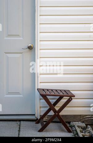 Wooden small table in front of a doorway to a storing unit Stock Photo