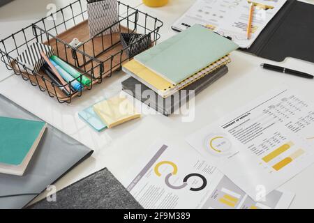 Close-up of financial reports with books and notebooks on the table Stock Photo