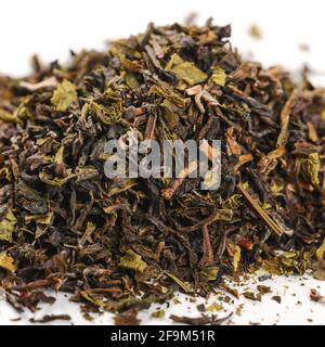 pile of loose green tea - dry green tea leaf isolated on white background Stock Photo