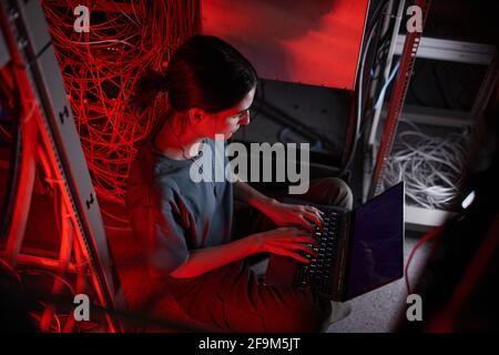 High angle view at young woman wearing military uniform while using computer in server room Stock Photo