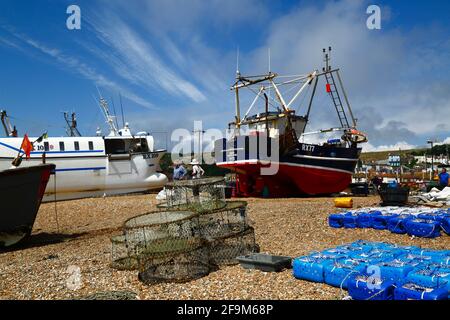 Fishing boat and crab traps on The Stade shingle beach, Hastings, East Sussex, England, UK Stock Photo