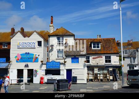 The London Schooner rock shop, Shores Seafood Bar and Royal Standard pub on A259 sea front in Old Town, Hastings, East Sussex, England Stock Photo