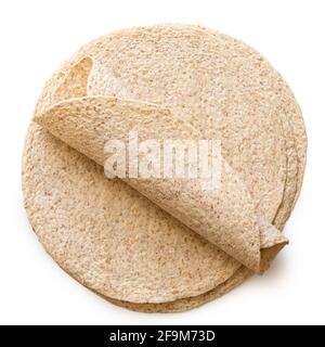 Rolled up tortilla on top of a stack of plain spelt and oat tortilla wraps isolated on white. Top view. Stock Photo