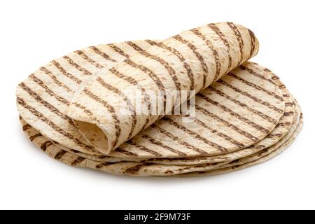 Folded tortilla on top of a stack of plain tortilla wraps with grill marks isolated on white. Stock Photo