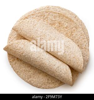 Two rolled up tortillas on top of a stack of plain spelt and oat tortilla wraps isolated on white. Top view. Stock Photo