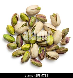 Pile of shelled pistachios and pistachios in shell isolated on white. Top view. Stock Photo