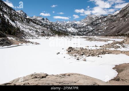 Lake Sabrina is a reservoir in Inyo County, CA, USA that is still frozen in the spring each year. Stock Photo
