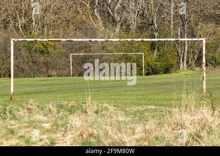 Old rusty metal goal posts Stock Photo