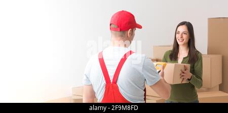 happy young woman receiving a parcel delivered by courier Stock Photo