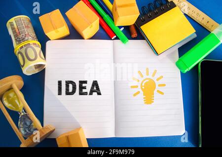 Notebook with word Idea and light bulb idea icon. Concept of new innovation ideas and discoveries. Vision, planning. Strategy and management. Business Stock Photo