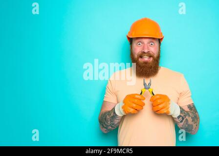 Incompetent worker is unsure about his work. cyan background Stock Photo