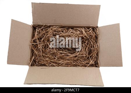 Shredded brown paper packaging in cardboard box Stock Photo
