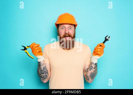Incompetent worker is unsure about his work. cyan background Stock Photo
