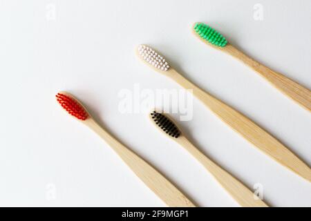 Four multi-colored bamboo toothbrushes  lie on a pastel background. Eco friendly stuff concept. Copy space. Horizontal orientation. Top view. Stock Photo