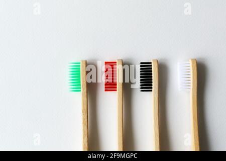 Four multi-colored bamboo toothbrushes . Eco friendly stuff concept. Copy space. Horizontal orientation. Top view. Stock Photo