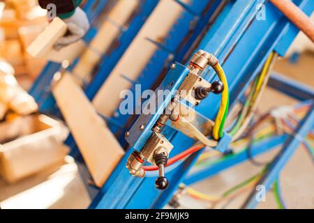 Control switch on toggle as a part of machinery at woodwork factory Stock Photo