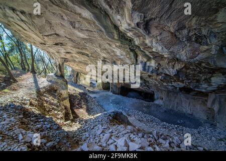 Beautiful Limestone cave, Old Oolitic stone quarries in Massone, The extracted stone, called 'statuary stone'Arco, Italy. Bosco Caproni Stock Photo