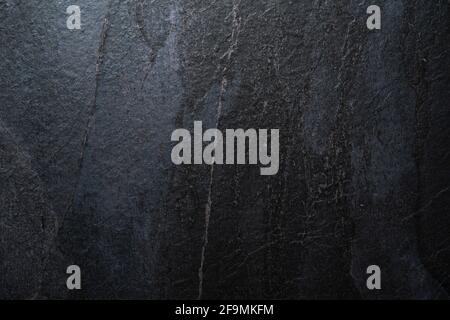 dark gray and blue natural stone background. abstract texture with gradient. rough stone wall with copy space Stock Photo