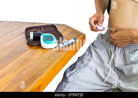 Diabetes patient gets an insulin injection in abdomen area over white ...