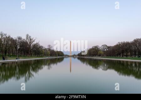 Washington Monument reflecting in the Lincoln Memorial Reflecting Pool at sunset in Washington, DC. Stock Photo
