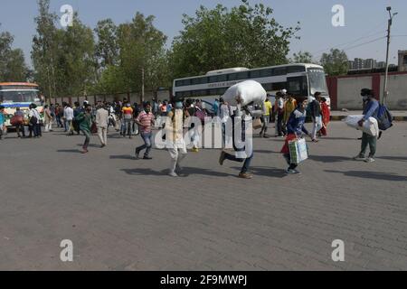 New Delhi, India. 19th Apr, 2021. Due to outbreak of Covid -19 Delhi government has imposed a 7 day lockdown in state. That's why labourer migrating to there native place at Kaushambi bus stand in Delhi NCR. (Photo by Ishant Chauhan/Pacific Press) Credit: Pacific Press Media Production Corp./Alamy Live News Stock Photo