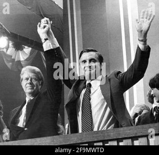 **FILE PHOTO** Walter Mondale Has Passed Away. Governor Jimmy Carter (Democrat of Georgia), the 1976 Democratic Party nominee for President of the United States, left, and US Senator Walter Mondale (Democrat of Minnesota), the 1976 Democratic Party nominee for Vice President of the US, right, acknowledge the cheers of the delegates following their acceptance speeches at the 1976 Democratic Convention at Madison Square Garden, New York, New York on July 15, 1976. Credit: Frank Jurkoski/CNP /MediaPunch Stock Photo
