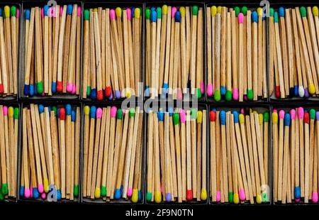 multicolored match sticks in boxes on a black background Stock Photo