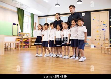 Teachers and children in classroom Stock Photo