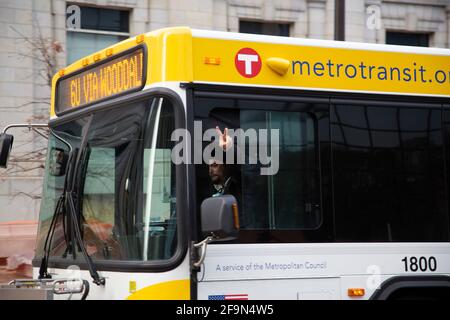 Minneapolis, Minnesota, USA. 19th Apr, 2021. April 19, 2021-Minneapolis, Minnesota, USA: A Metro Transit bus driver flashes the peace symbol at passing protestors. Over 400 demonstrators marched through Downtown Minneapolis shortly after closing arguments in Derek Chauvin's trial concluded. Chauvin, of Oakdale, Minnesota, is being tried for the murder of George Floyd while on duty as a Minneapolis police officer on May 25, 2020. Credit: Henry Pan/ZUMA Wire/Alamy Live News Stock Photo