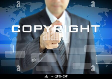 Businessman pointing to COPYRIGHT word - piracy concept Stock Photo