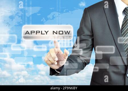 Businessman hand touching APPLY NOW button on virtual screen Stock Photo