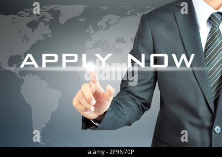 Businessman hand touching APPLY NOW sign on virtual screen Stock Photo