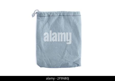 Small pouch or bag made of gray fabric with drawstring - isolated on white Stock Photo