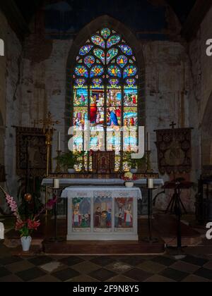 The stained glass window and new altar in Saint Goulven church, Finister, Brittany France. Stock Photo