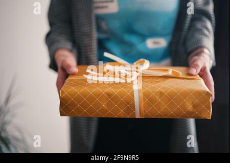 Midsection of woman holding present Stock Photo