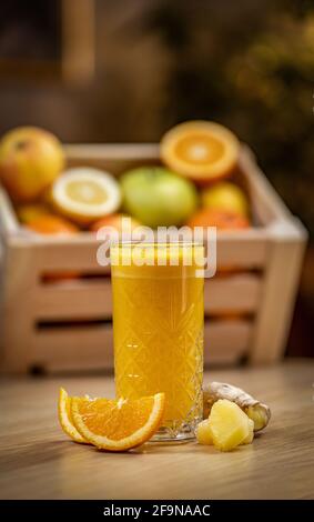 Healthy orange, pineapple and ginger juice on wooden table, blurred background Stock Photo