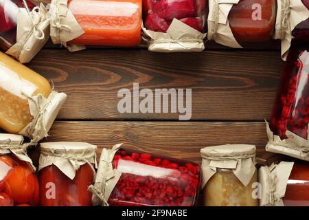 Banner or frame from assortment of canned vegetables and fruits in plastic free jars on wooden rustic table, flat lay, from above overhead top view, c Stock Photo