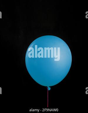 Beautiful blue balloon on black isolated background. Layout gift concept Stock Photo