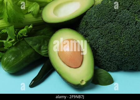 Fresh green vegetables on blue background, close up Stock Photo