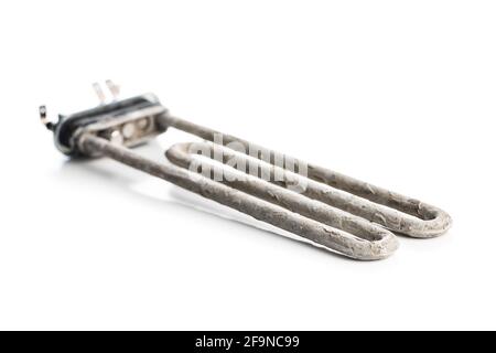 Old washing machine heater with limescale isolated on white background. Stock Photo