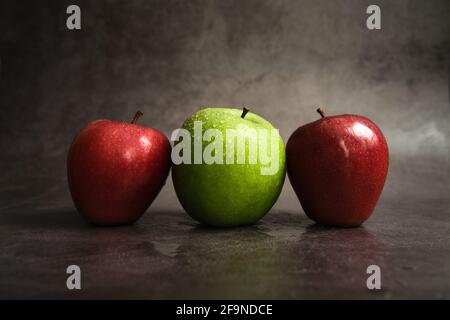 three apples on a dark background Stock Photo