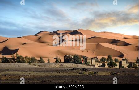 Dunes in the Sahara desert near Merzouga, Morocco, Africa at sunset. Beautiful sand landscape with stunning sky. Stock Photo