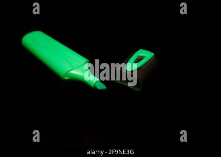 Green  marker pen and cap isolated on black close-up Stock Photo