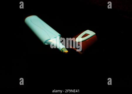 Blue  marker pen and cap isolated on black close-up Stock Photo