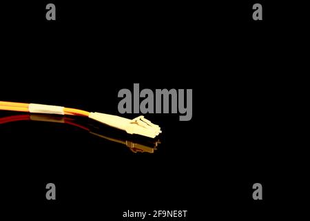 Twin optical fiber connectors  isolated on black with reflections Stock Photo