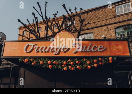 London, UK - August 12, 2020: Sign on the fresh Orange Juice stall in Camden Market. Started with 16 stalls in 1974, Camden Market is one of the busie Stock Photo